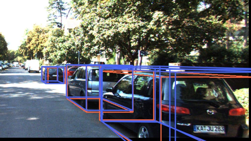 photo shows cars on a street, with each of them surrounded by lines indicating a bounding box