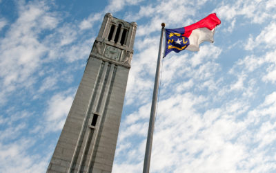 NC State's Memorial Belltower and North Carolina state flag
