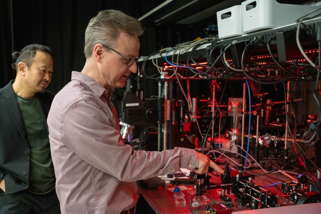 Two engineers examine equipment in a research lab