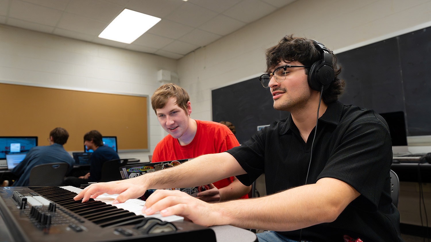 Students in a Music Technology class conduct a listening test.