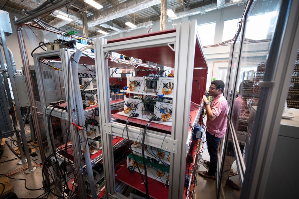 A technician works on server racks in a data center