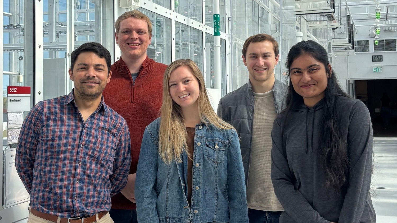Five students pose together