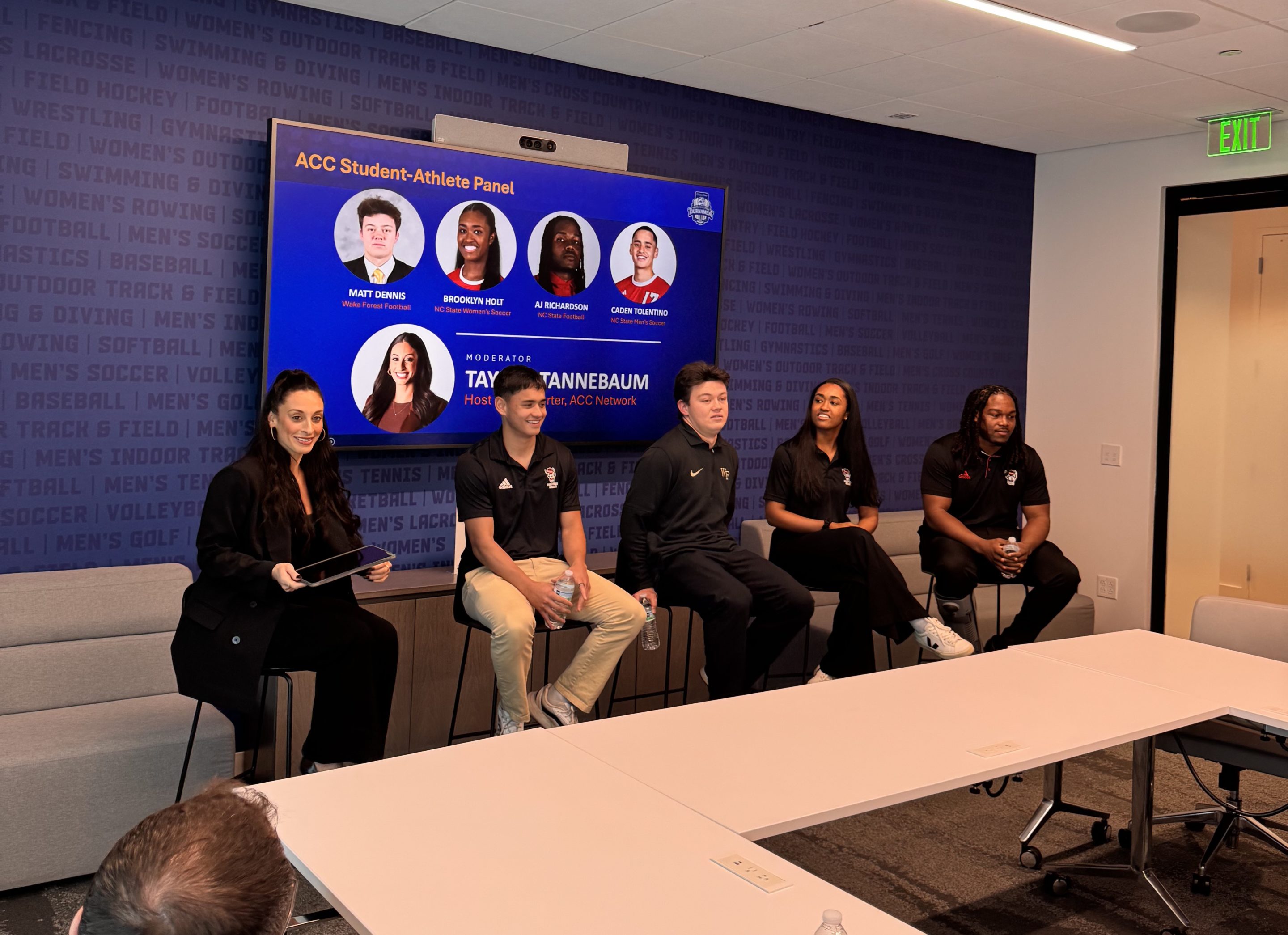 ACC student-athlete panel discussion with moderator in a conference room, featuring sports-themed graphics.
